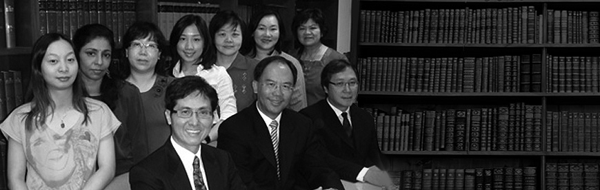 The Dominion LLC team in the firm's library: the three directors seated in front, seven colleagues standing behind